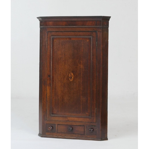 577 - Provincial oak and inlaid flat front hanging corner cupboard, early 19th Century, having a mahogany ... 