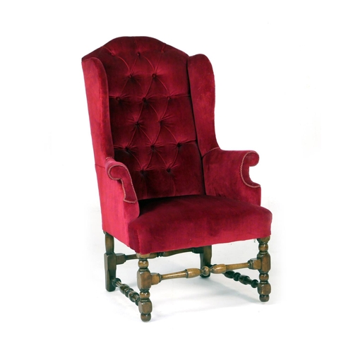 579 - William and Mary style upholstered wing armchair, upholstered in deep buttoned red fabric, raised on... 