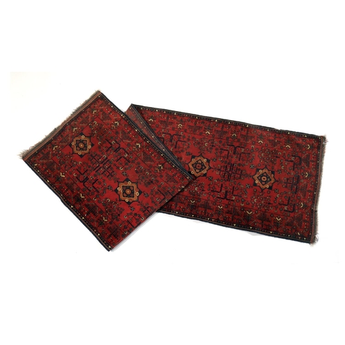 590 - Hamadan red ground runner, centred with star shaped medallions in brown, terracotta and blue, the fi... 