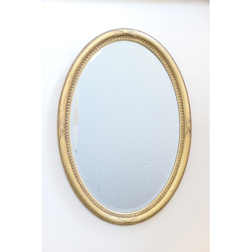 612 - Late Victorian gilt framed oval wall mirror, bevelled glass plate within a reed and ribbon border, 8... 