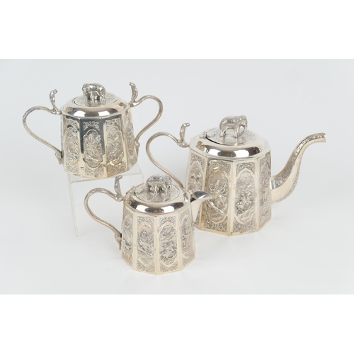 99 - Indian white metal three piece tea service, circa 1900, comprising lidded teapot, with elephant fini... 