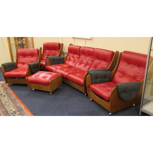 591A - K M Wilkins for G-Plan teak 'saddle' lounge suite, re-upholstered in red leather, comprising three s... 