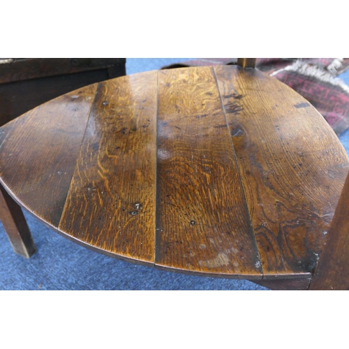 593 - Oak cricket table, early 19th Century, circular two plank top, 85cm diameter, raised on elm chamfere... 