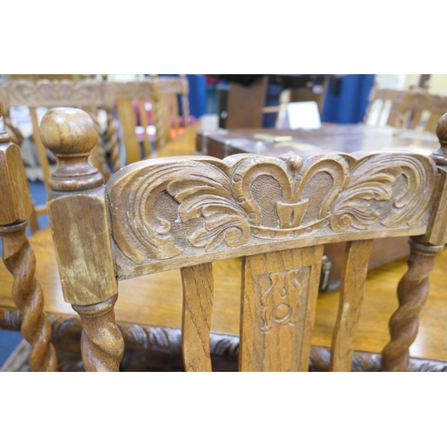 589 - Victorian carved oak extending dining table, and a set of twelve oak barleytwist dining chairs, the ... 