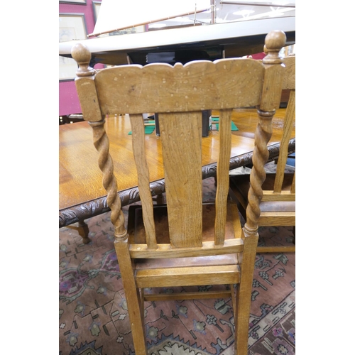 589 - Victorian carved oak extending dining table, and a set of twelve oak barleytwist dining chairs, the ... 