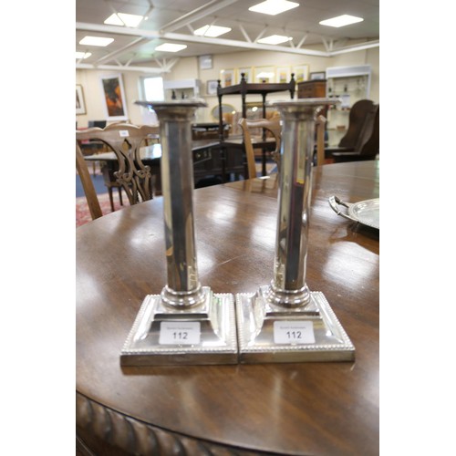 112 - Pair of late Victorian silver candlesticks, by Martin Hall & Co., Sheffield 1896, with square nozzle... 