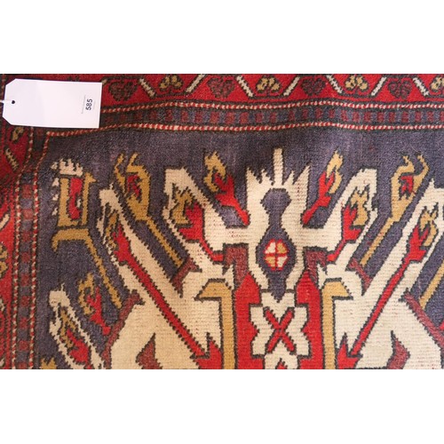 585 - Kazak rug, having three medallions in fawn, red and blue against an abrashed blue field with red run... 