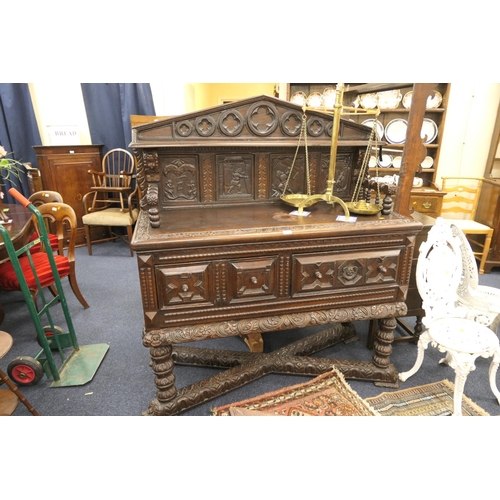 521 - Unusual carved oak sideboard with spurious date, width 137cm