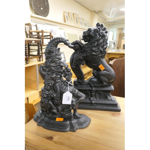 433 - Victorian cast iron lion passant doorstop, height 38cm; also a Mr. Punch cast iron doorstop, 32cm (2... 