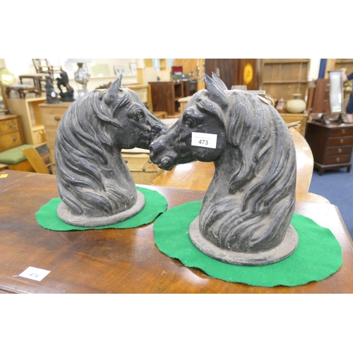 473 - Pair of cast iron horse head post finials, the circular base 17cm diameter, height 27cm