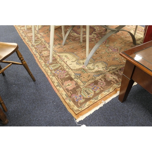 573 - Heriz carpet, central brown, blue and mauve medallion against a light brown ground, size approx. 291... 