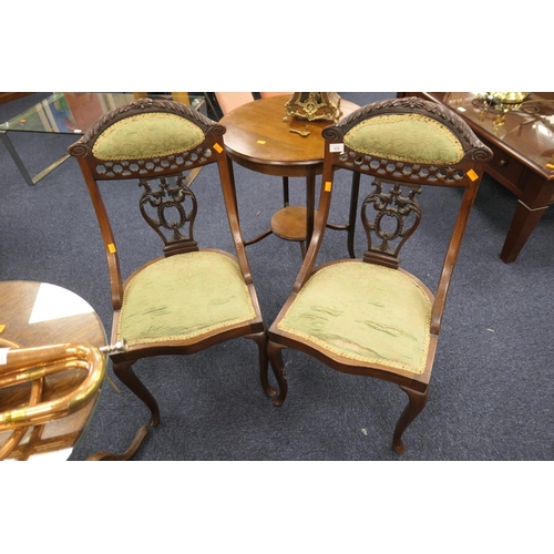 578 - Pair of late Victorian and carved mahogany salon chairs with upholstered pad backs and seats