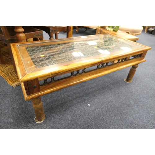 537 - Eastern hardwood and wrought metal glass topped coffee table, 123cm x 62cm