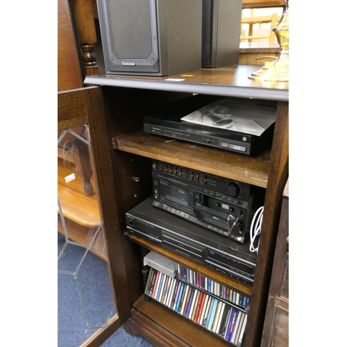 550 - Technics stacking stereo system with CD player, number of CDs, all contained within an oak glazed ca... 