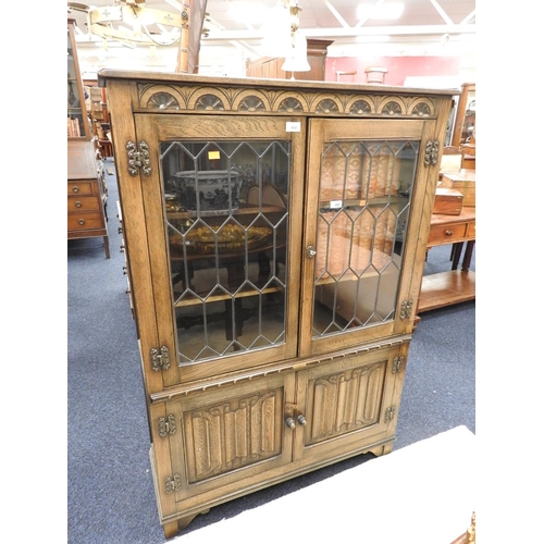 494 - Oak linenfold and leaded glass bookcase, width 95cm, height 138cm