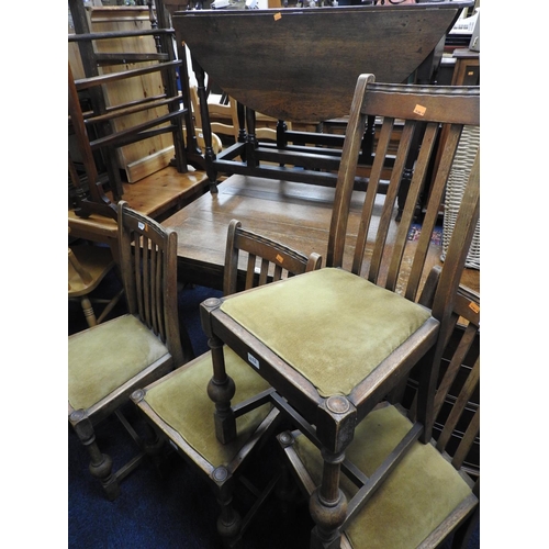 422 - Oak drawer leaf dining table on claw and ball feet and four oak lath back dining chairs (5)