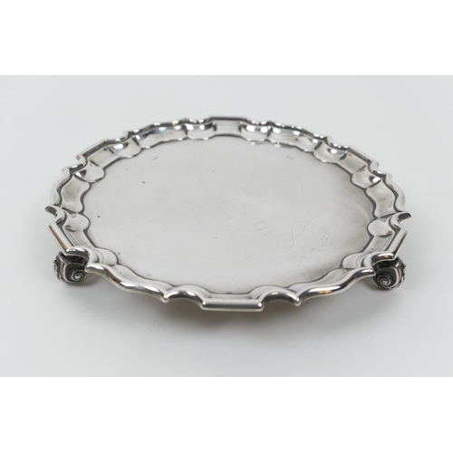 105 - George V silver card tray, by TB&S, London 1916, circular form with raised border, raised on three s... 