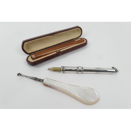 108 - Sampson Mordan & Co. silver propelling pencil, London 1946, 7.5cm; also a 9ct gold mounted amber col... 