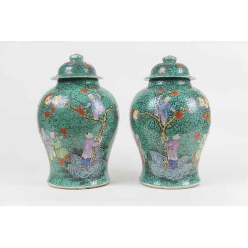 13 - Pair of Chinese green glazed lidded jars, 19th Century, decorated with boys picking pomegranates in ... 