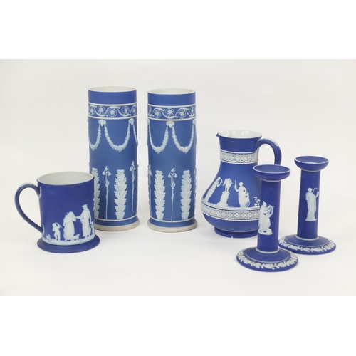 14 - Small selection of Wedgwood dark blue jasper wares comprising two cylinder vases, 25cm and 24.5cm; a... 