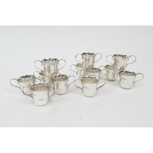 162 - Two sets of six Edwardian silver miniature porringers, London 1904 and 1907, plain form with reeded ... 