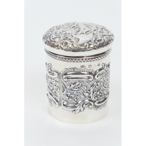 166 - Late Victorian silver jar, Birmingham 1898, repousse decorated throughout and with a cherub to the c... 