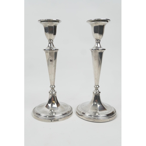 179 - Pair of Edwardian silver candlesticks, Sheffield 1904, tapered octagonal form over a circular loaded... 