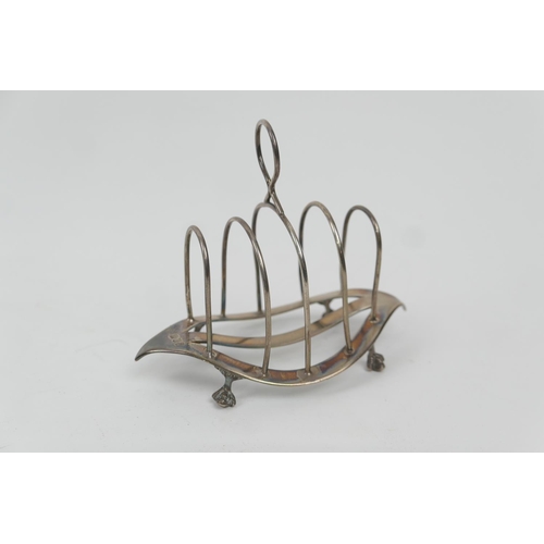 189 - Late Victorian silver toast rack, by William Hutton & Sons, London 1899, four divisions, raised on c... 