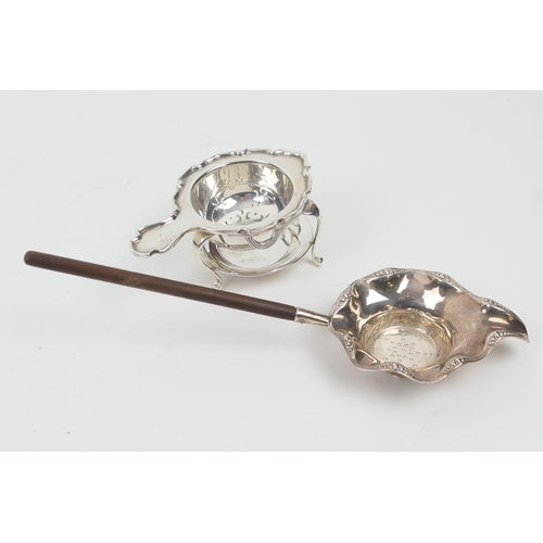 193 - Sterling silver tea strainer, with wooden handle, import marks, 21cm; also another silver tea strain... 