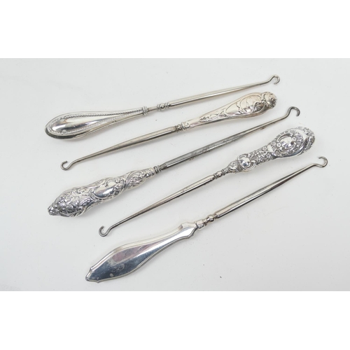 209 - Five silver handled steel button hooks, various hallmarks