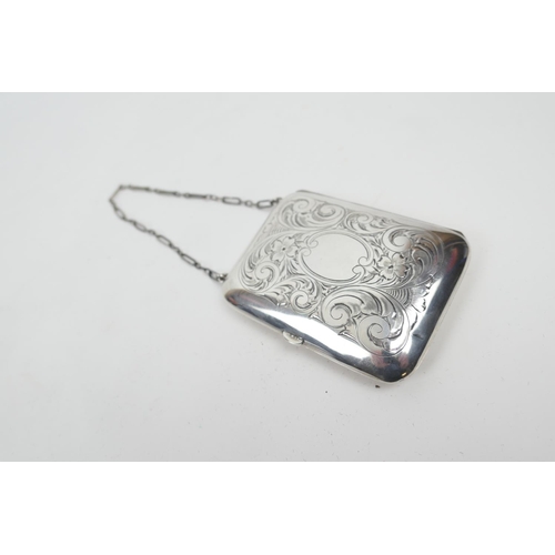 210 - Sterling silver purse, circa 1920, rectangular cushion form with foliate engraving, opening to a cer... 