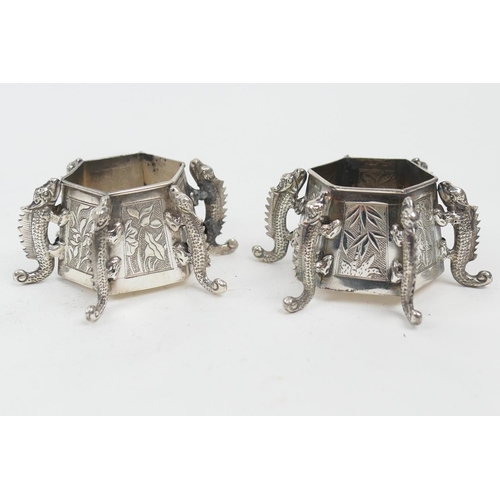 213 - Pair of Chinese silver salts, late 19th Century, each of hexagonal form with applied dragon supports... 