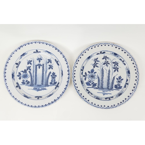 28 - Pair of delft blue and white plates, circa 1740-80, decorated with a formal design of flowers and re... 