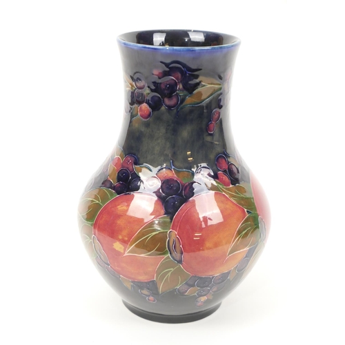 34 - William Moorcroft pomegranate vase, baluster form with a wide neck, deep blue ground, impressed and ... 