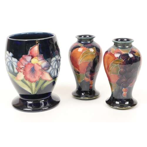 35 - Pair of Moorcroft pomegranate small vases, inverted baluster form, impressed 'Burslem' mark and gree... 