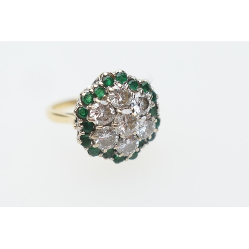 396 - Unusual diamond and emerald cluster ring, centred with seven round cut diamonds totalling approx. 1.... 