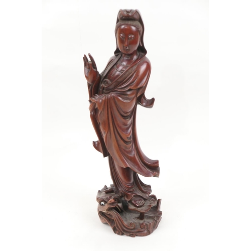 678 - Chinese carved wooden figure of Guanyin, the deity carved standing on a lily pad and water dragon, h... 