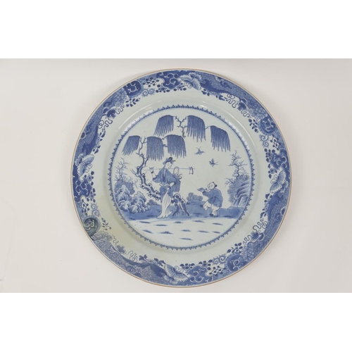 70 - Chinese Export blue and white charger, Qianlong (1736-95), decorated with figures under a willow tre... 