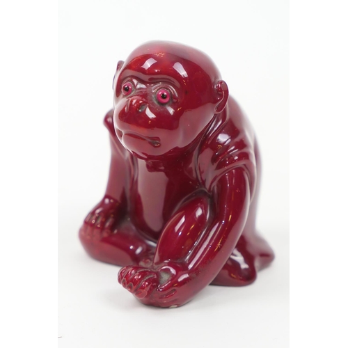 87 - Bernard Moore red flambe monkey figure, with original glass eyes, marked with initials 'BM', height ... 