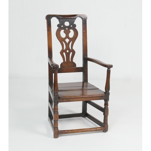 887 - Provincial oak joined armchair, early 18th Century, having a pierced splat back, open arms, solid se... 