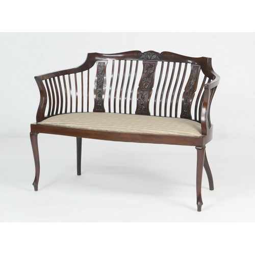 895 - Late Victorian mahogany window seat, circa 1900, the curved stick back with three carved foliate spl... 