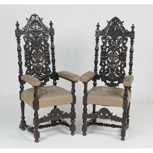 910 - Pair of Victorian heavily carved ebonised oak armchairs, in 17th Century style, with light brown flo... 