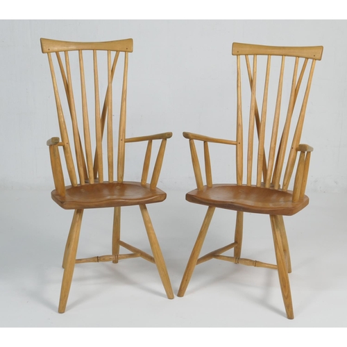 912 - Pair of hand crafted ash and elm comb back Windsor chairs, shaped seat and urn legs with H-stretcher... 