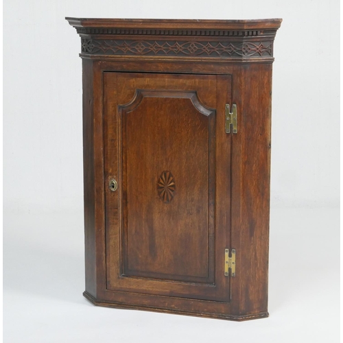 928 - George III oak and inlaid flat front corner cupboard, circa 1800-20, having a dentil cornice with bl... 