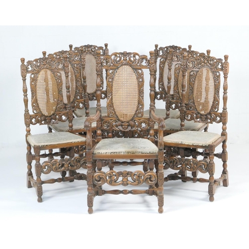 933 - Set of seven carved oak dining chairs in the Carolean style, comprising six singles and one carver, ... 