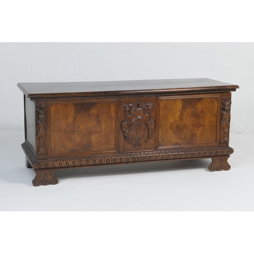 934 - Italian walnut cassone, 19th Century, the hinged top opening to a candle box, the front centred with... 