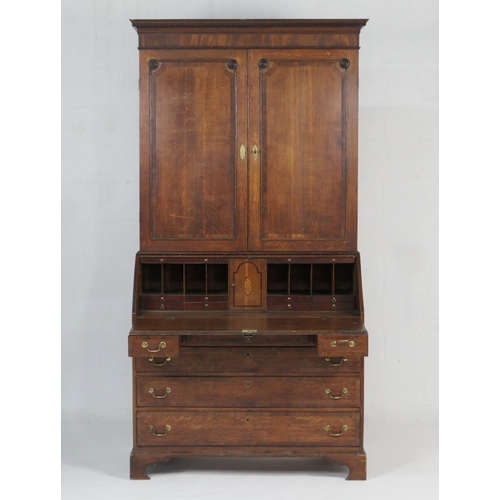 947 - Late George III oak bureau bookcase, circa 1800-20, dentil moulded cornice over two moulded panel do... 