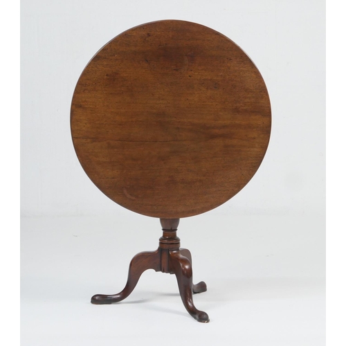 955 - Mahogany tilt top tripod table, late 18th Century, circular folding top over a turned urn column and... 