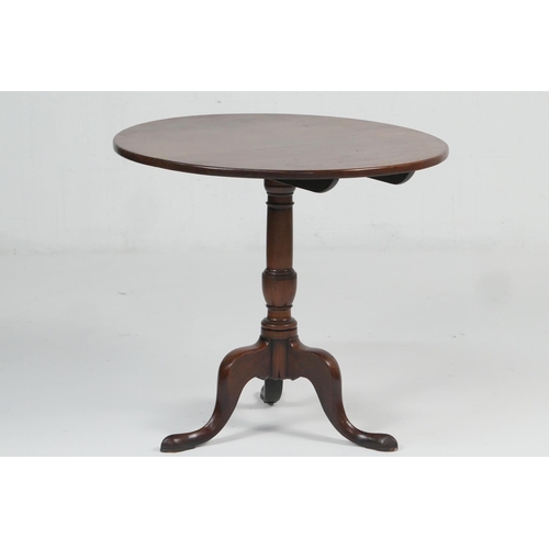 955 - Mahogany tilt top tripod table, late 18th Century, circular folding top over a turned urn column and... 