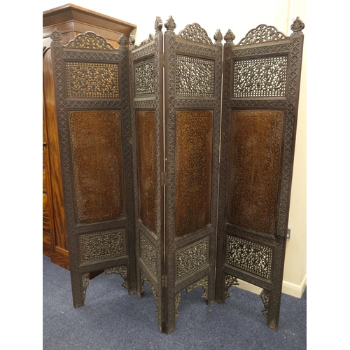 959 - Indian carved hardwood and brass inlaid panelled four fold dressing screen, circa 1900, height 187cm... 